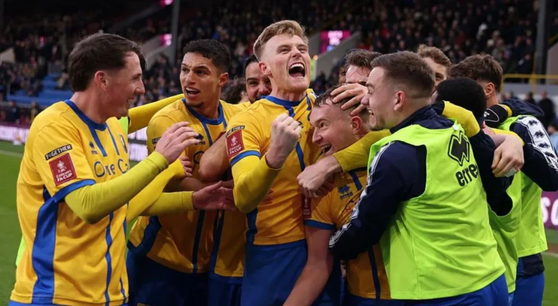 Mansfield players celebrate together after scoring at Turf Moor