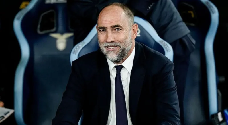 Igor Tudor smiles and is wearing a suit and tie