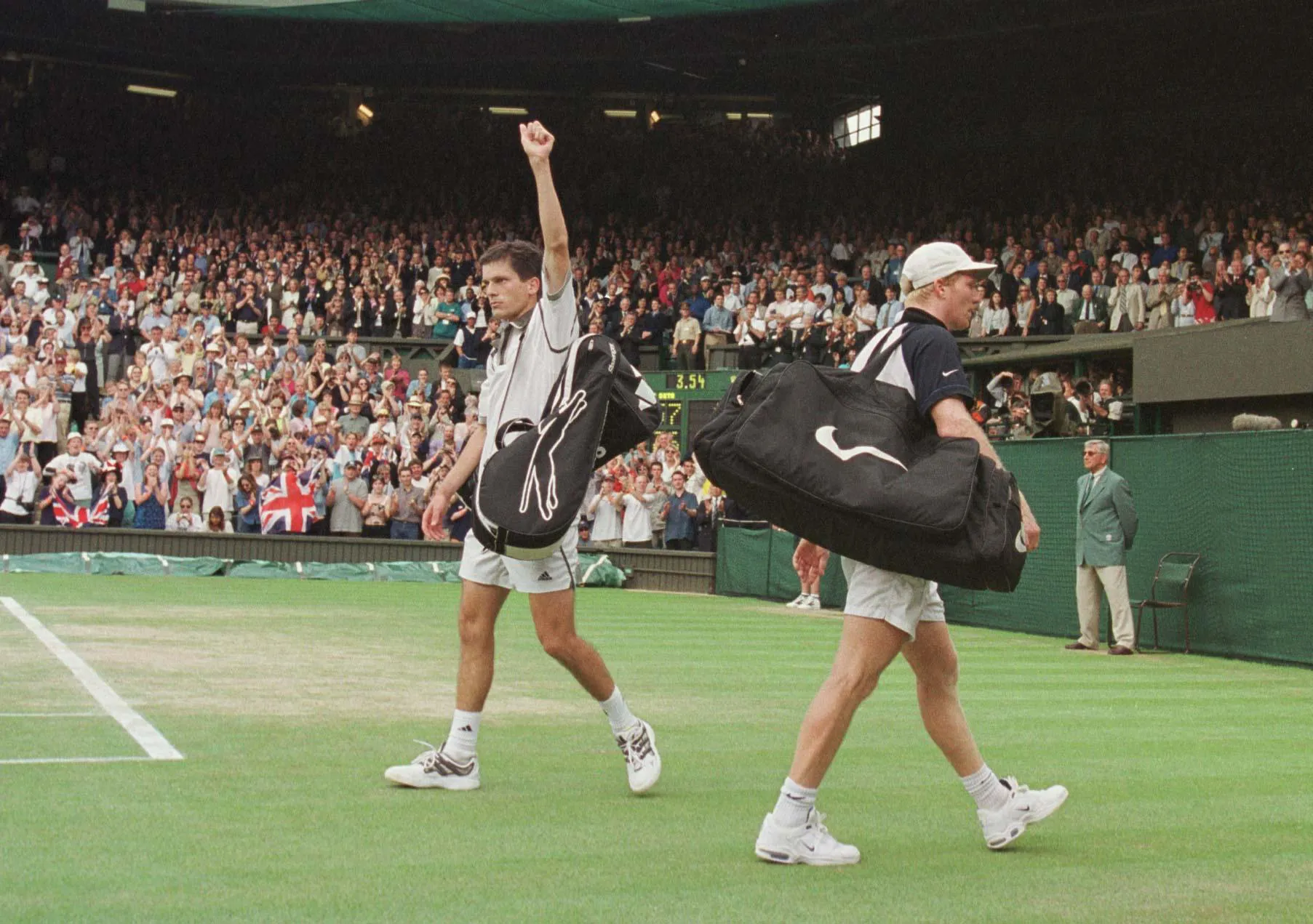 Tim Henman raises his fist in the air after beating James Courier in the fourth round of Wimbledon in 1999