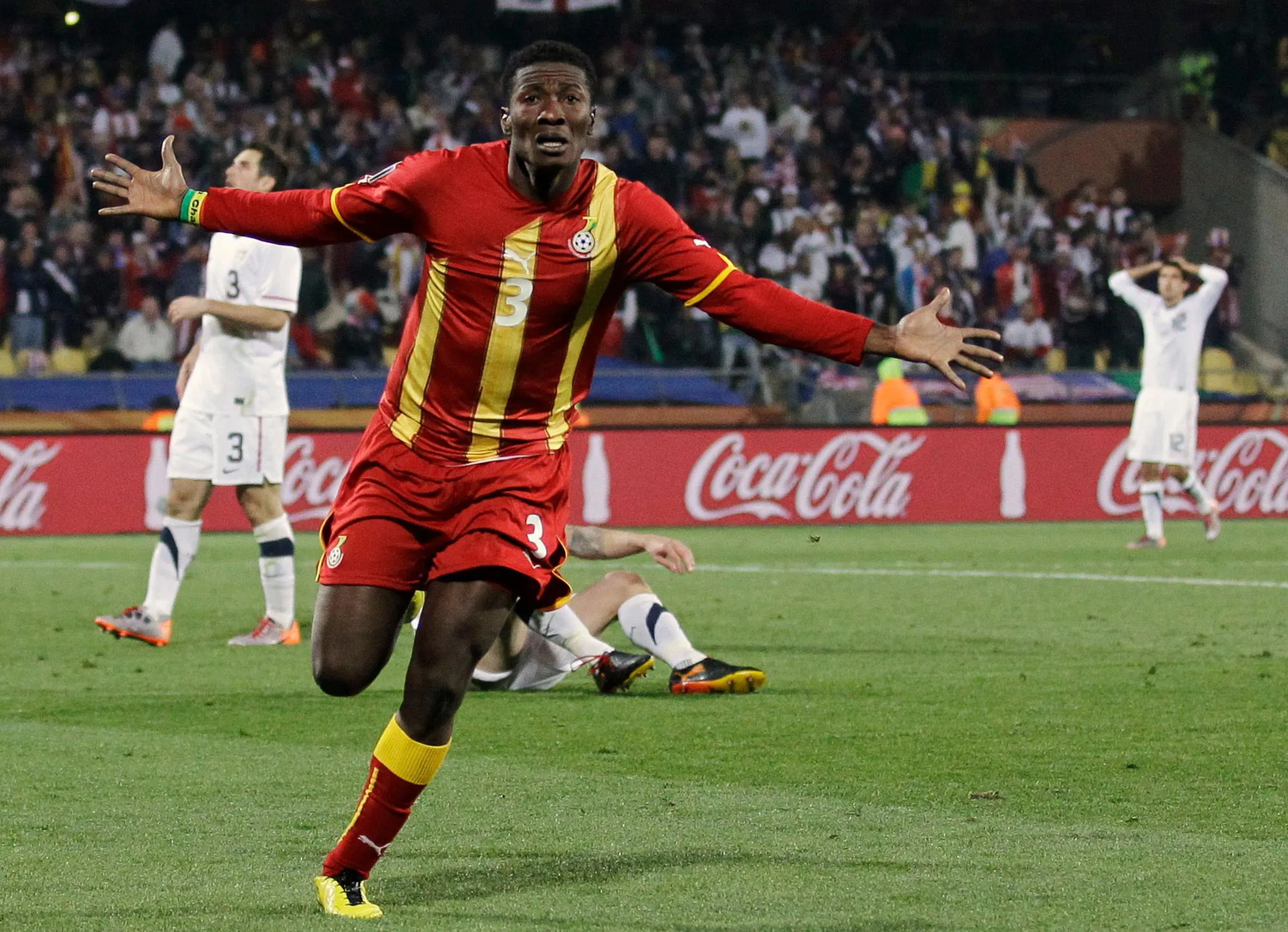 Asamoah Gyan celebrates his goal with outstretched arms