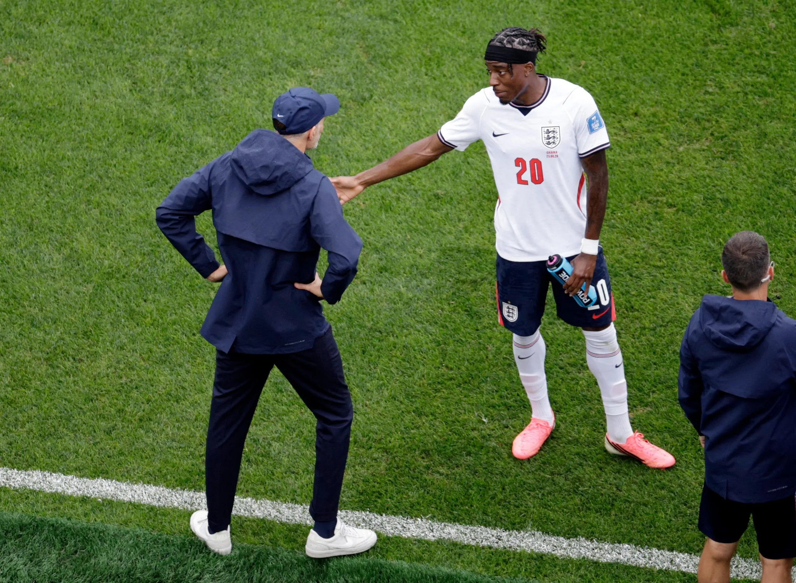 England manager Thomas Tuchel gives instructions to Noni Madueke during a break in play