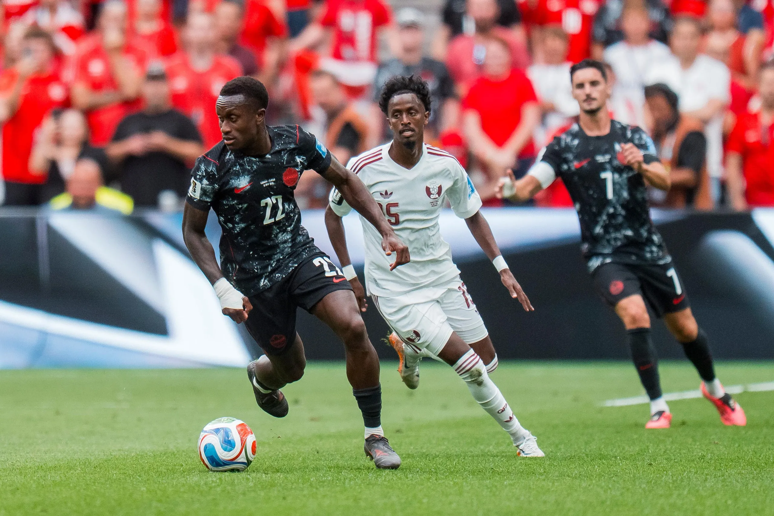 Qatar’s Al-Hashmi Al-Hussain chases Richie Laryea 