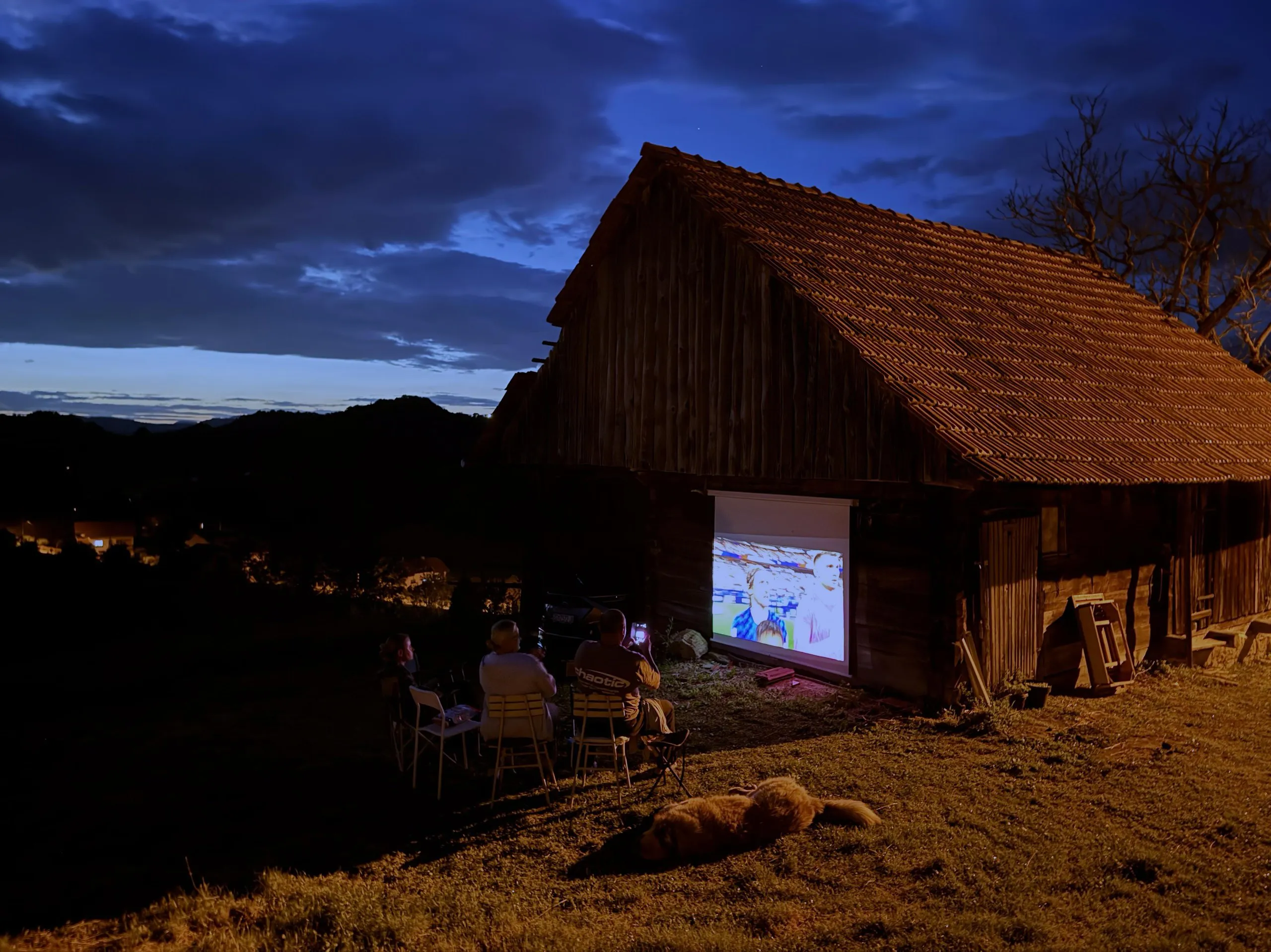 Locals in Kumrovec, northern Croatia, watch a projection of the match between England and Croatia on a barn wall.