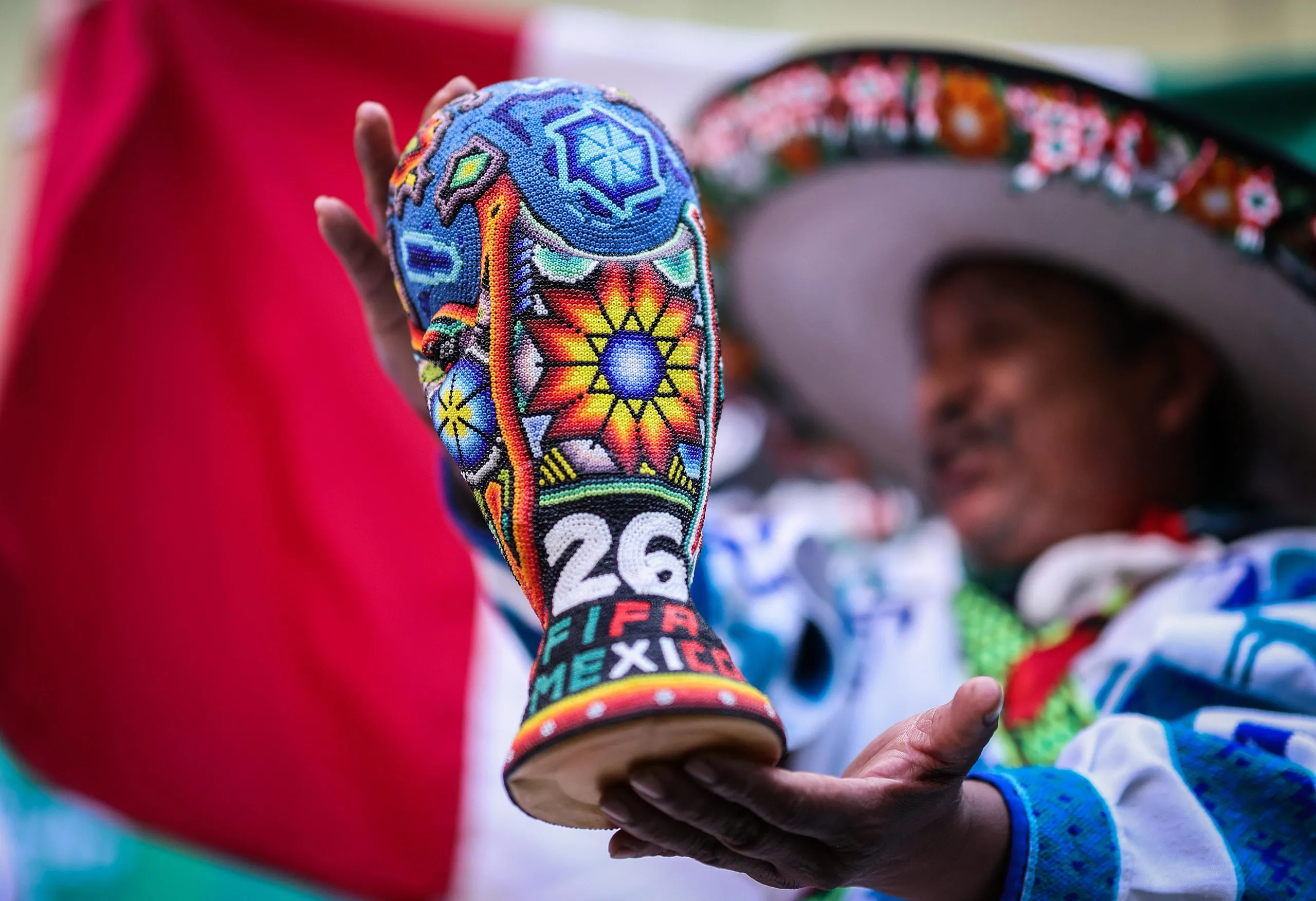 A Mexico fan is seen holding a decorated replica of the World Cup trophy before the 2026 World Cup Group A match between Mexico and South Korea