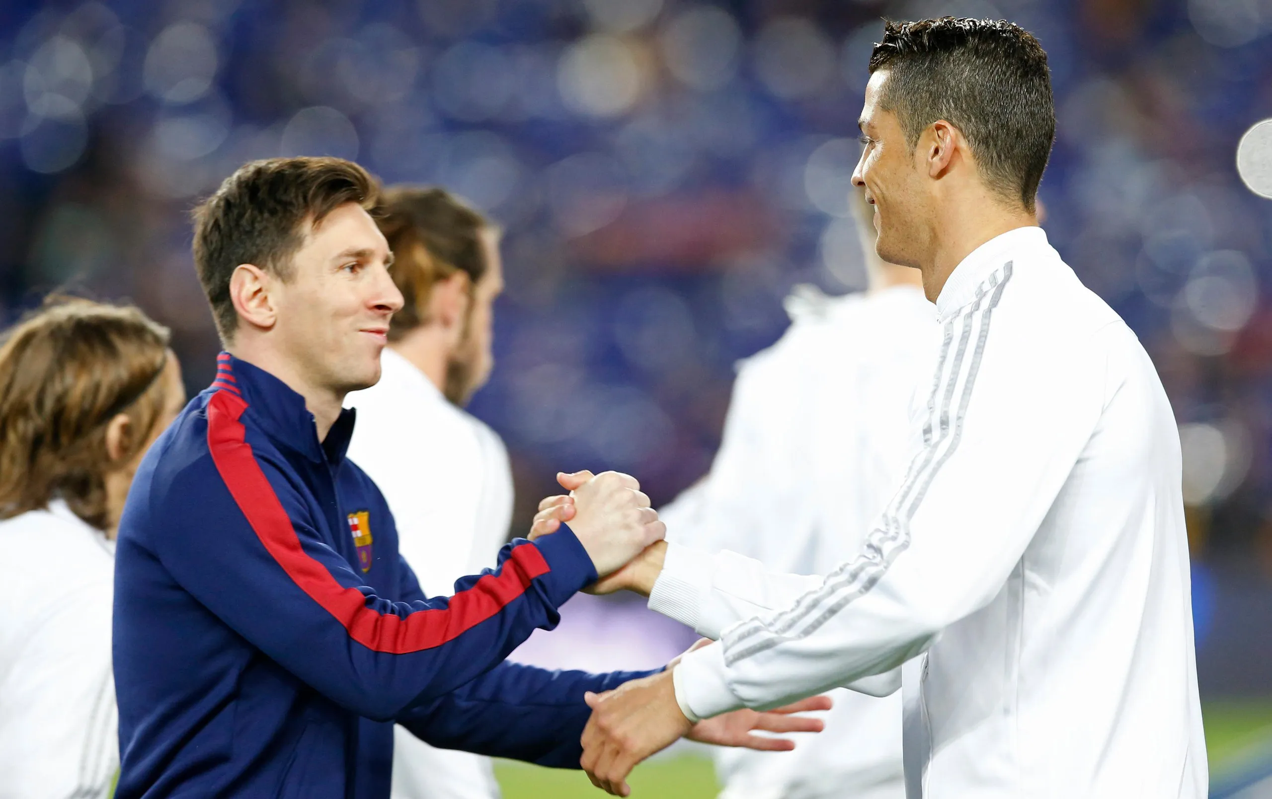 Lionel Messi shakes hands with Cristiano Ronaldo