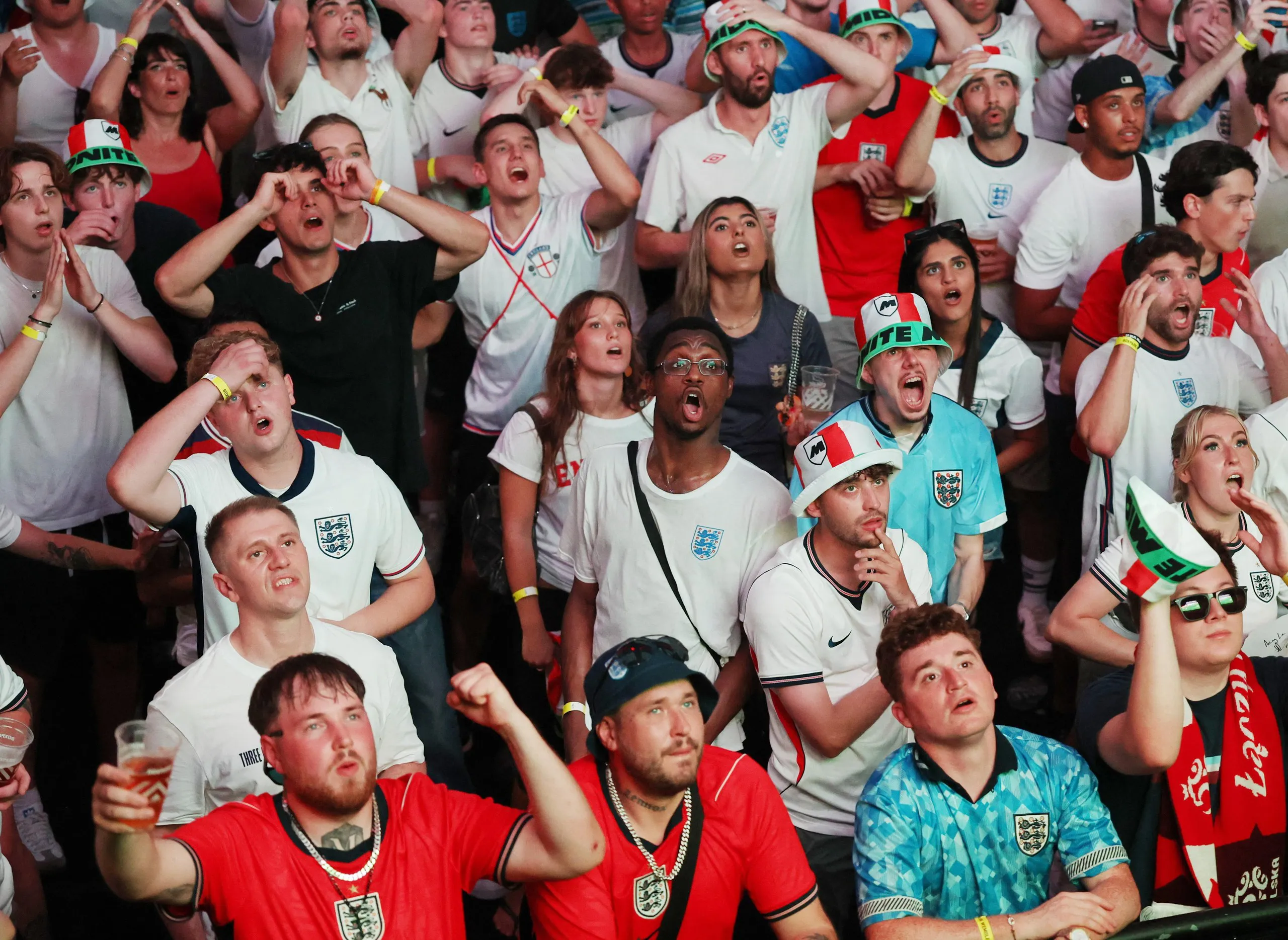 England fans at Boxpark in Wembley, London, react as they watch the match against Ghana.