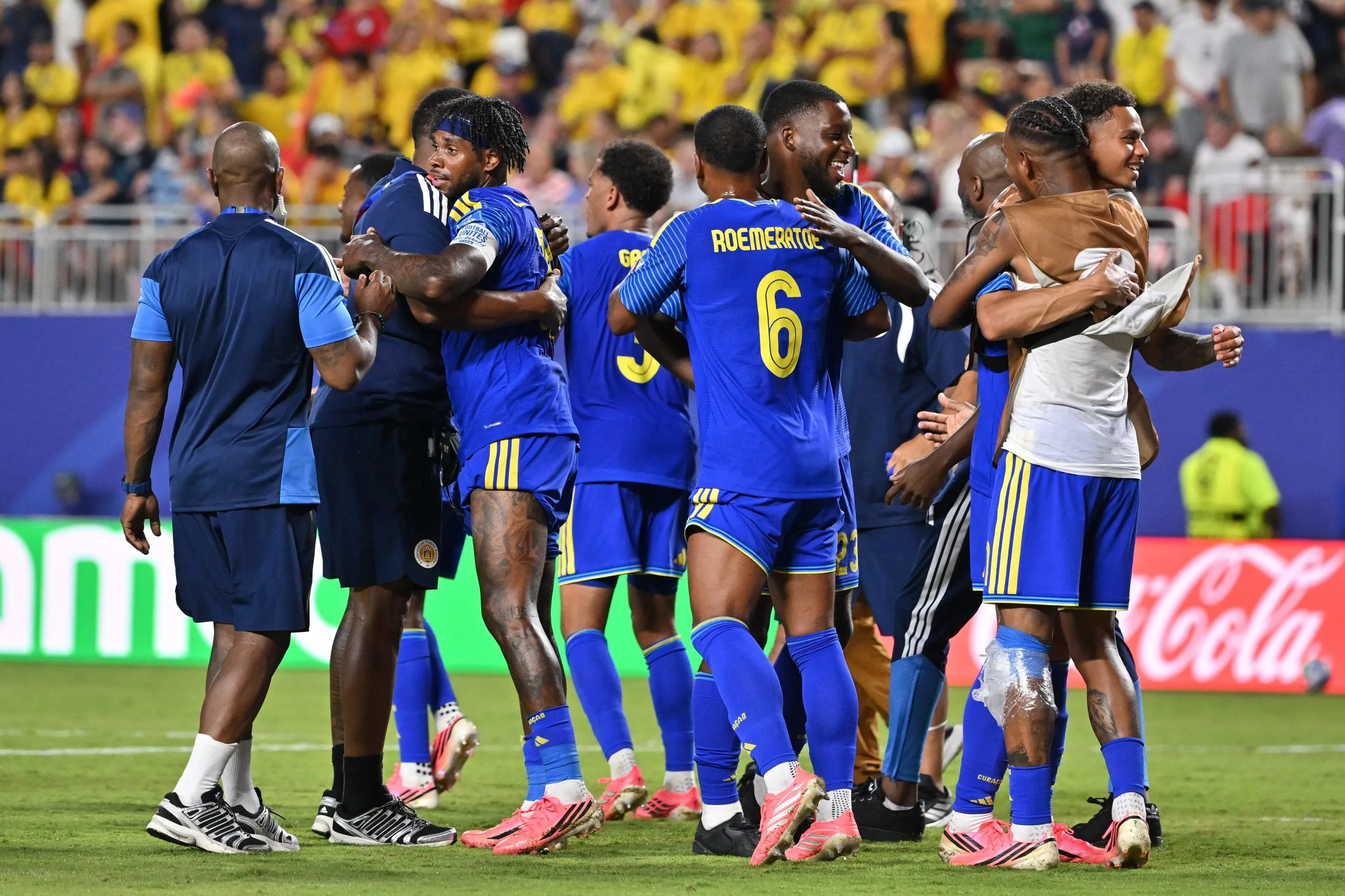 Curaçao players embrace on the pitch