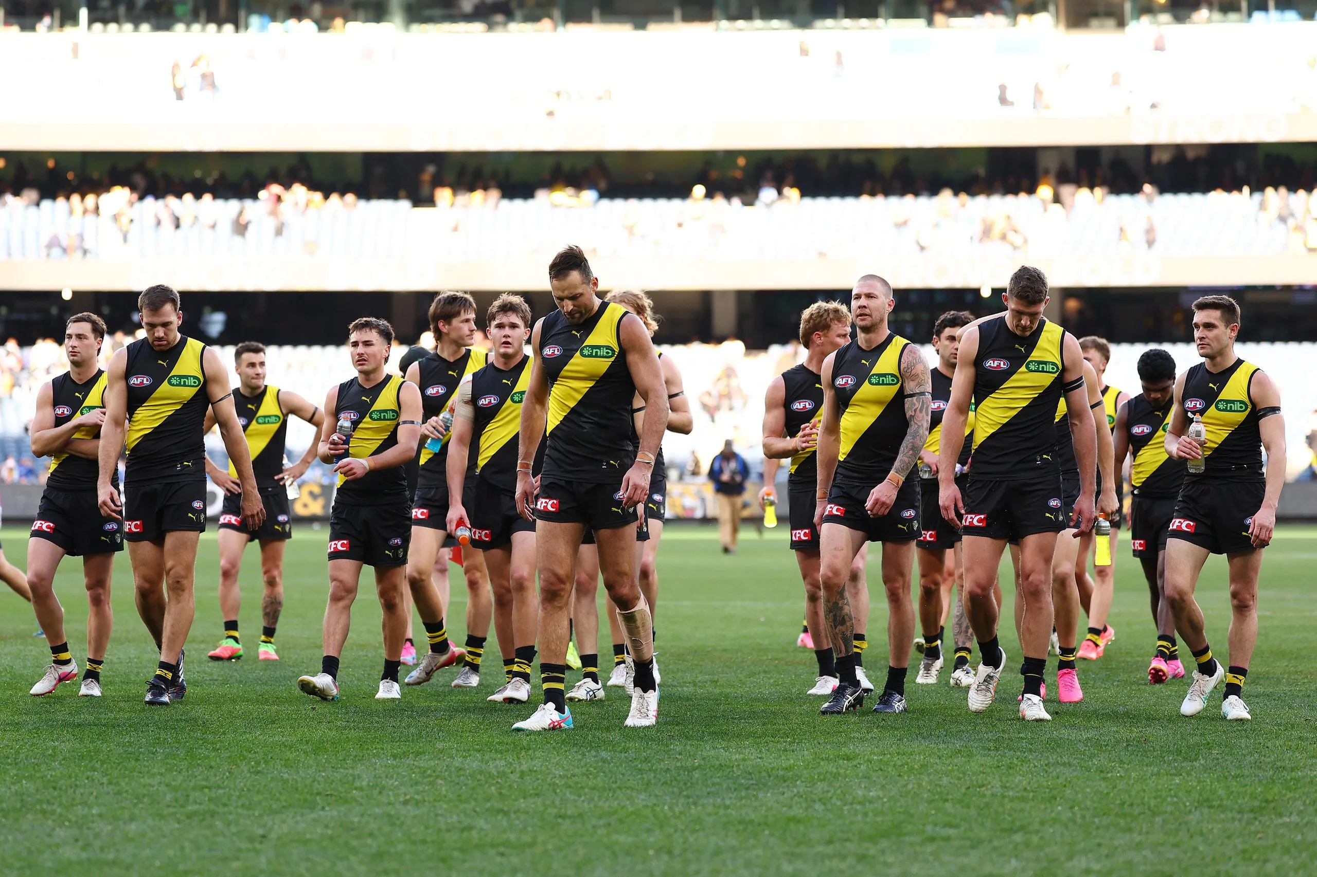 The Tigers leave the field dejected after their loss to North Melbourne