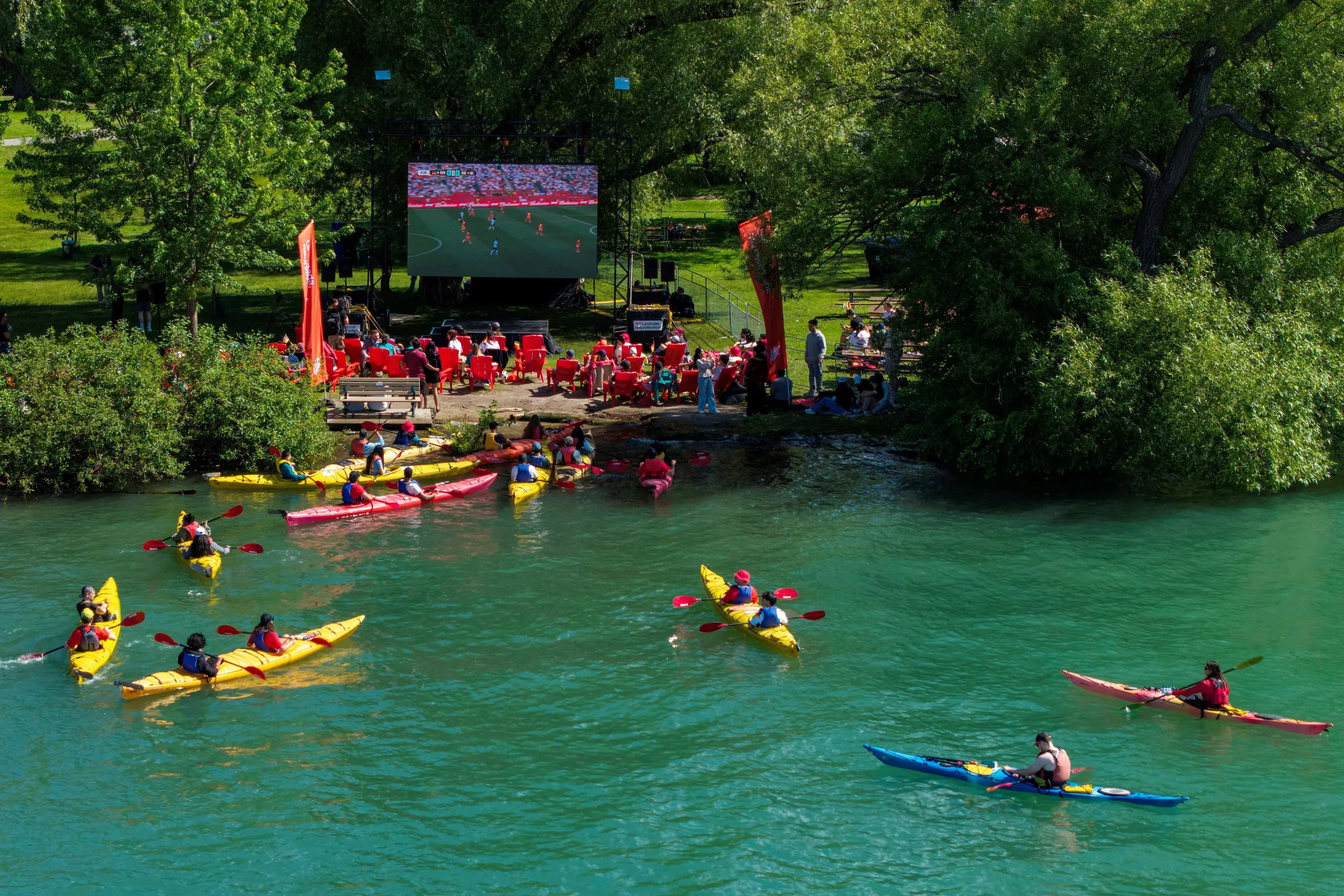A drone view shows fans in kayaks and canoes in at Olympic Island in Toronto, Canada, watching the match between Germany and Côte d'Ivoire.