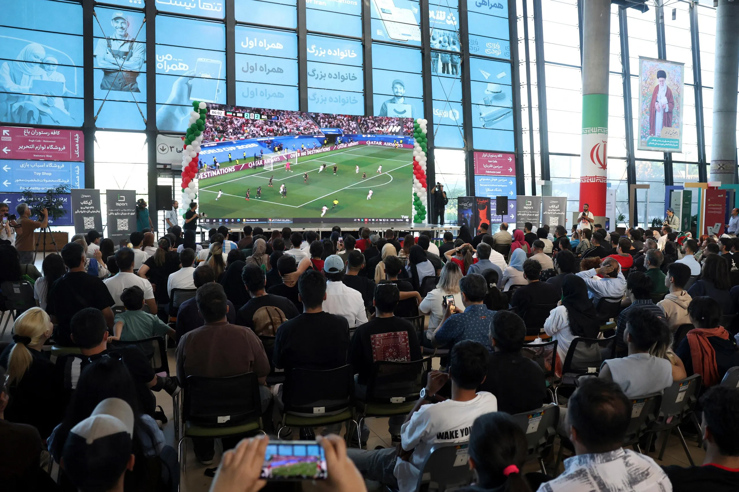 Iranian fans at at Tehran Book Garden in Tehran watching the match between Iran and New Zealand.