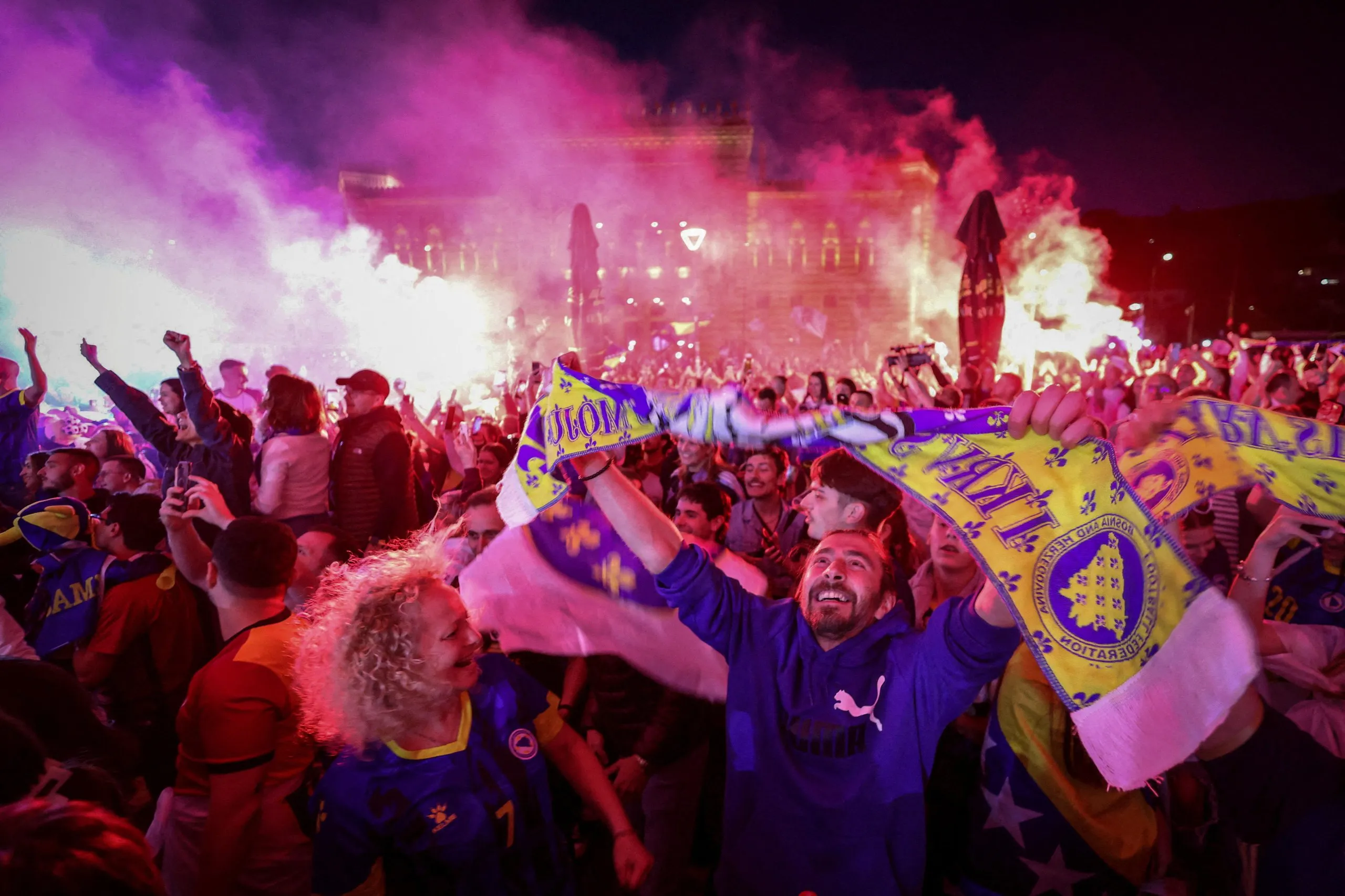 Bosnia and Herzegovina fans in Sarajevo celebrate with flares after Jovo Lukic scored their first goal against Canada.