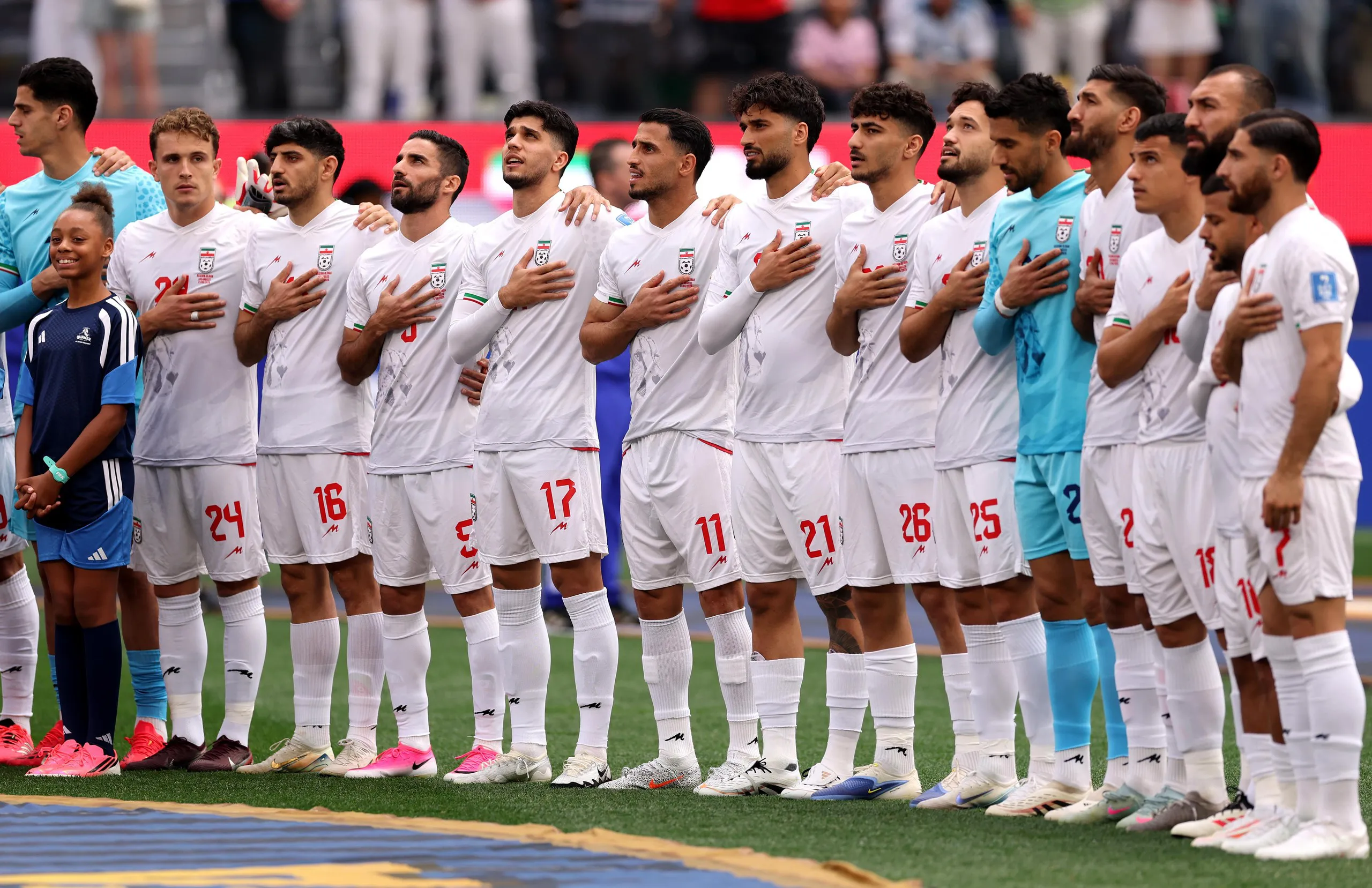Players of Iran line up for the national anthem.