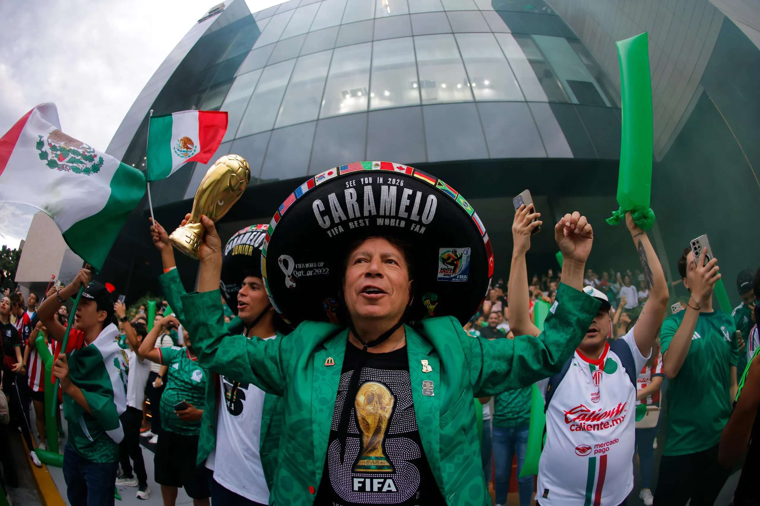 A Mexico fan in a sombrero cheers outside the team’s World Cup hotel.