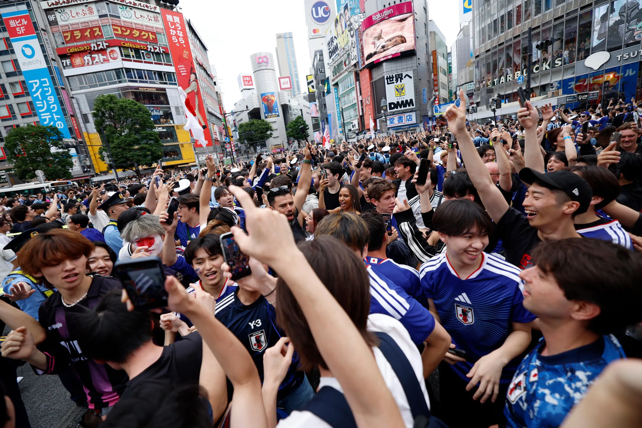 People at Shibuya crossing in Tokyo, Japan, celebrate Japan’s victory over Tunisia.