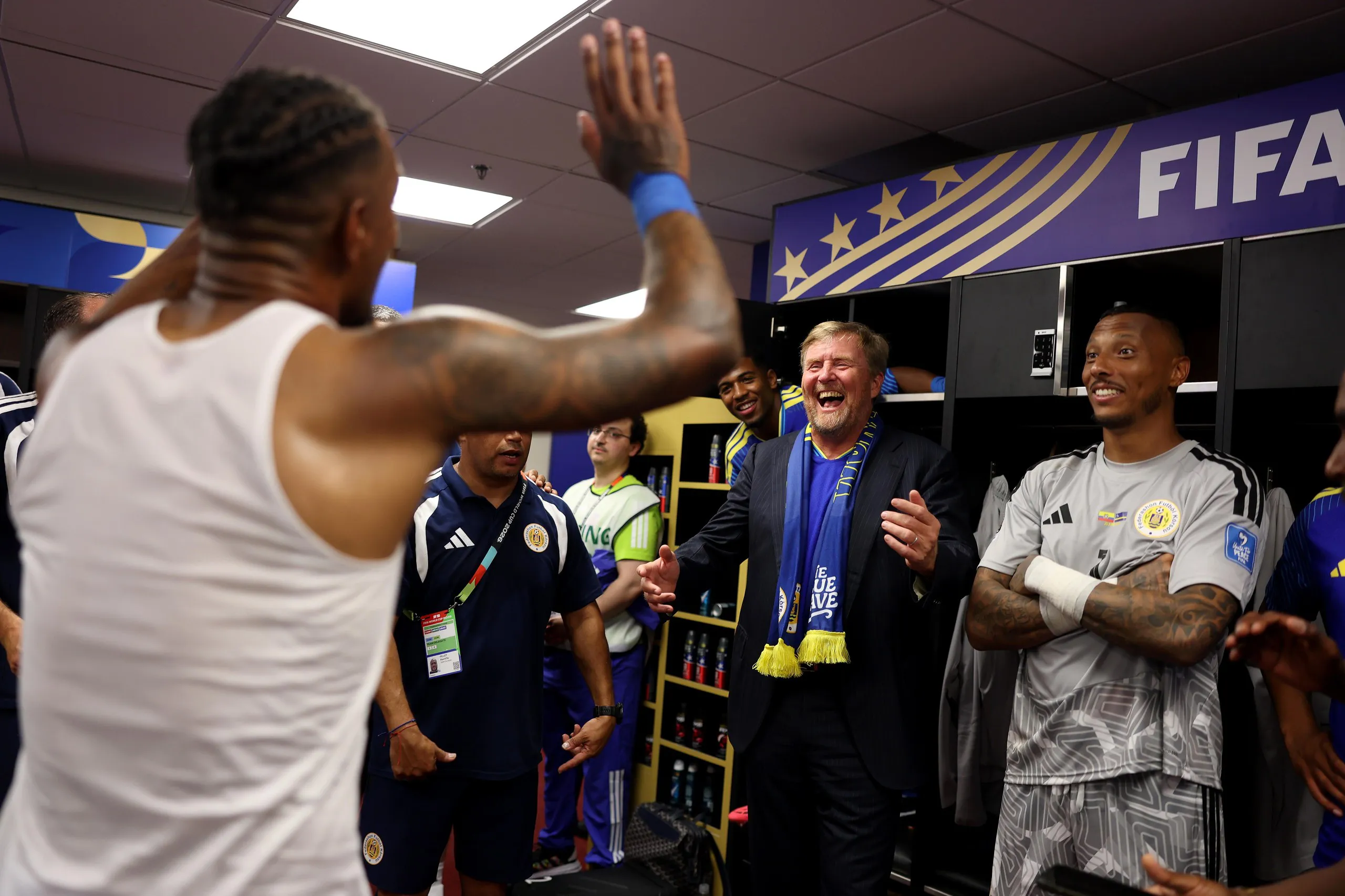 King Willem-Alexander of the Netherlands enjoys the celebrations in the Curaçao dressing room after the match.