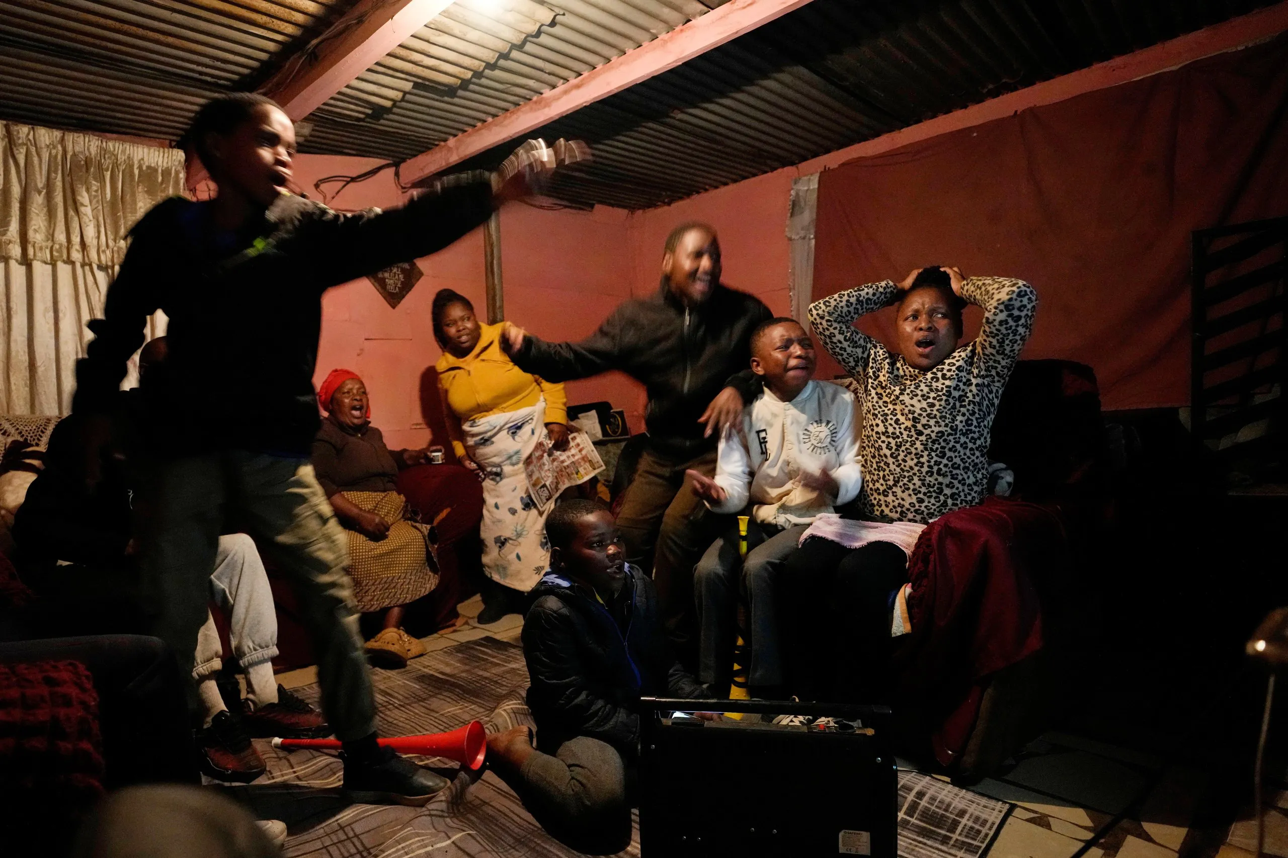 A family in Vereeniging, South Africa, watches a match on the opening day of the tournament.