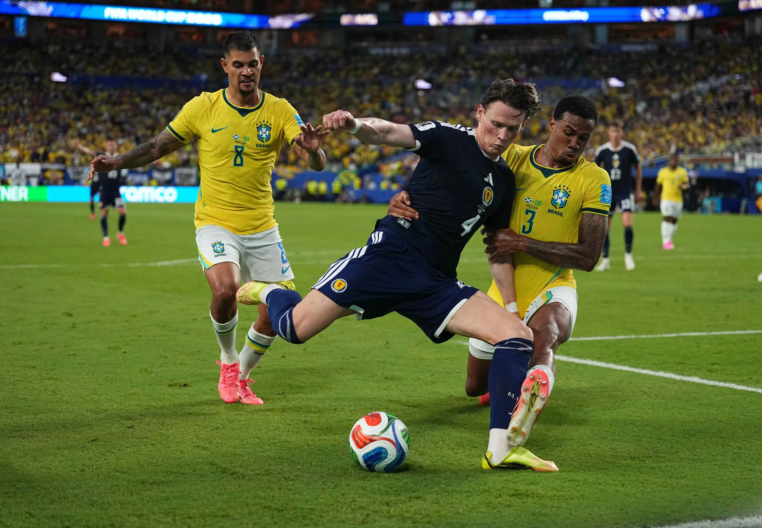 Scott McTominay and Gabriel Magalhães compete for the ball during Scotland’s World Cup defeat by Brazil.
