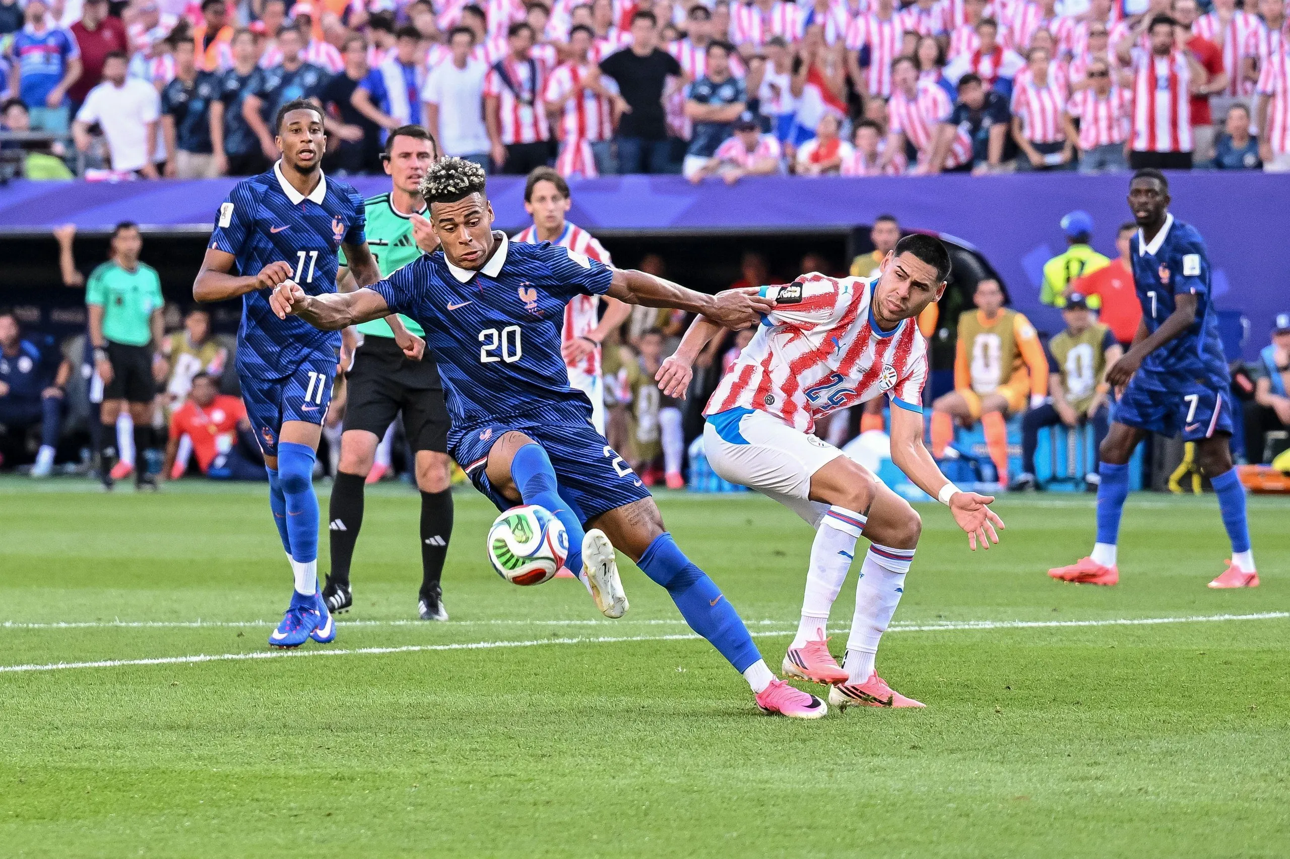 Désiré Doué battles for the ball with Gustavo Caballero trying to stop him