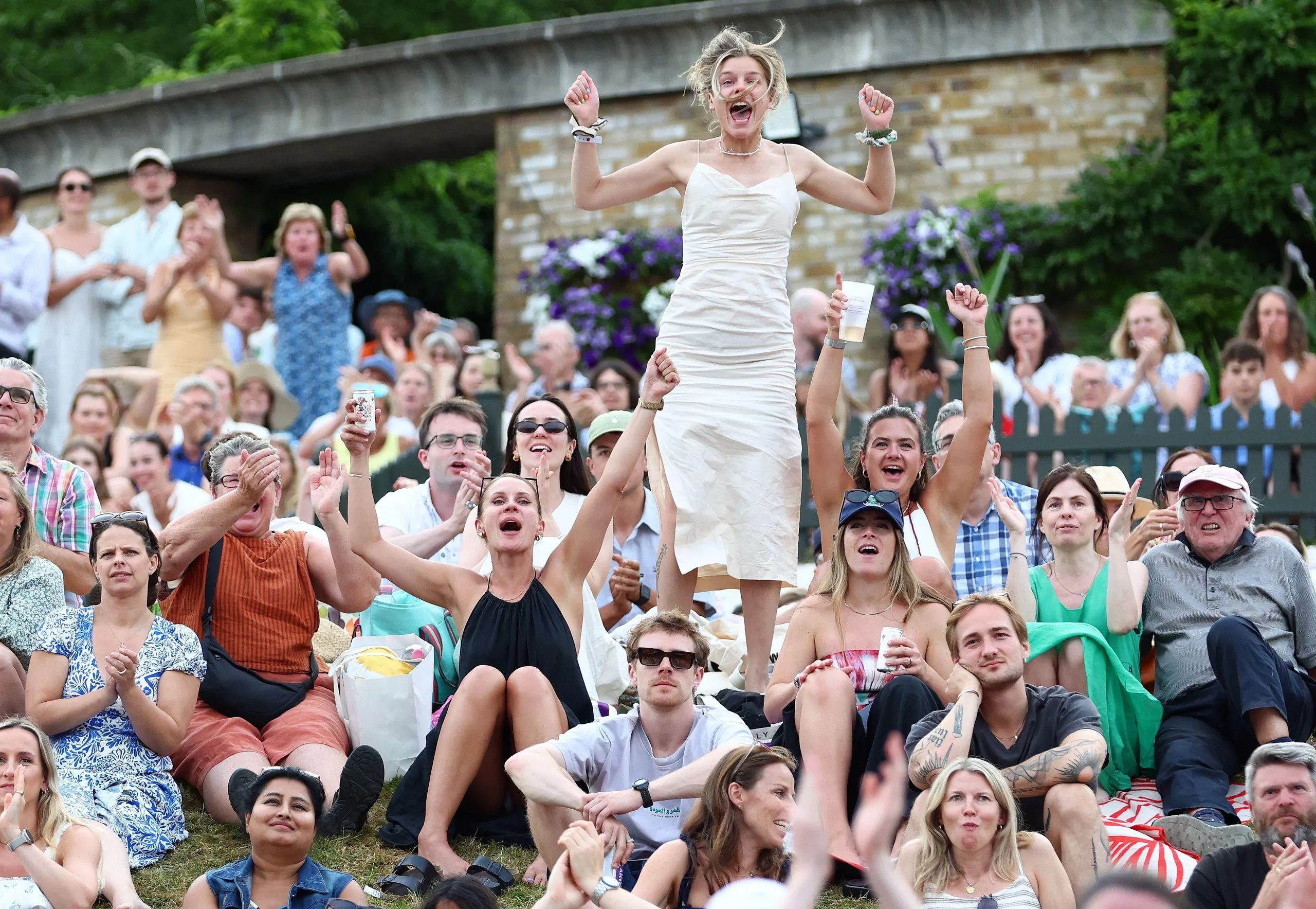 Fans on Henman Hill celebrate as Arthur Fery wins his fourth round match against Grigor Dimitrov on day eight.