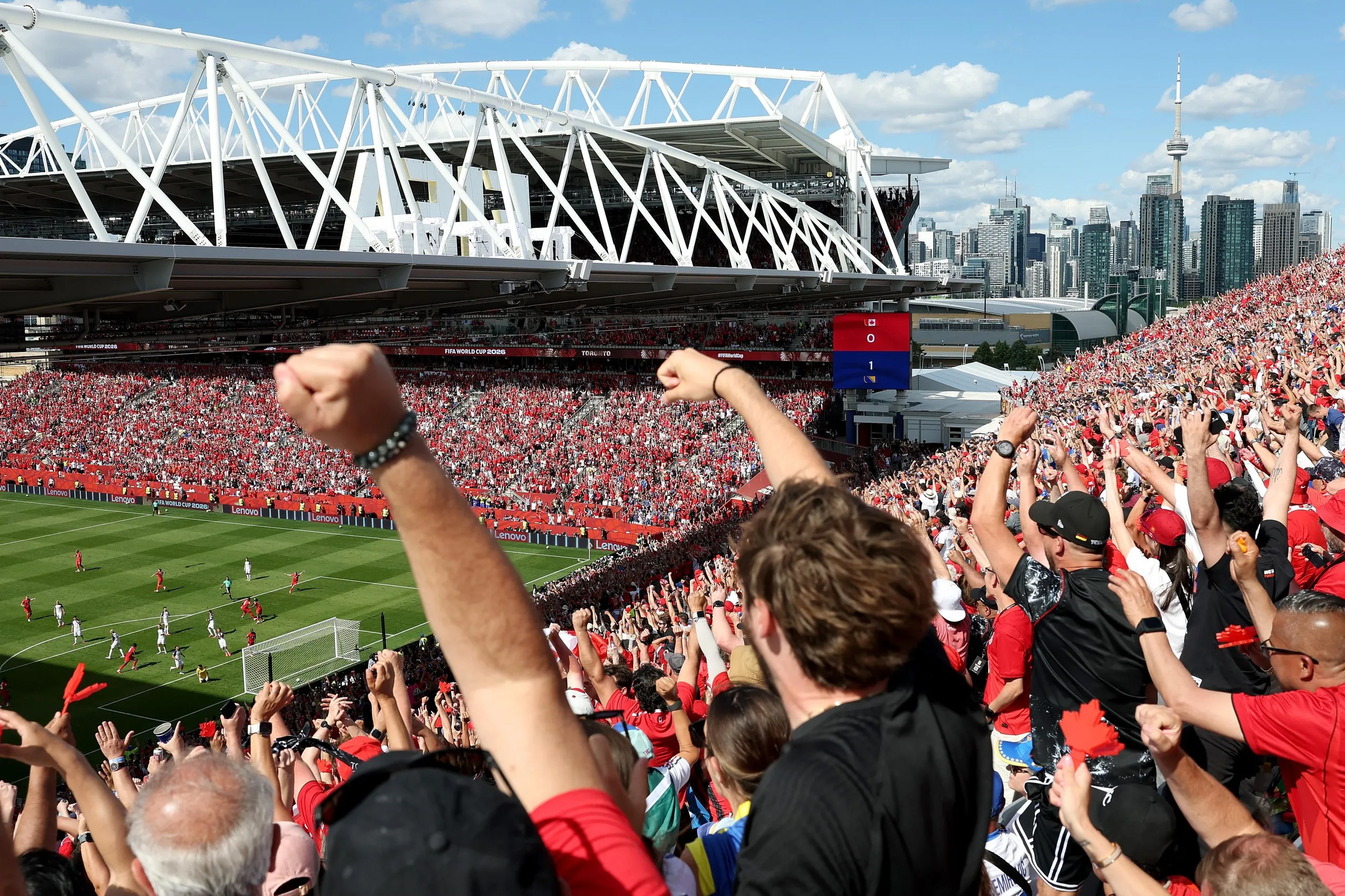 Canada fans react to Cyle Larin’s goal during their opening group game against Bosnia and Herzegovina.