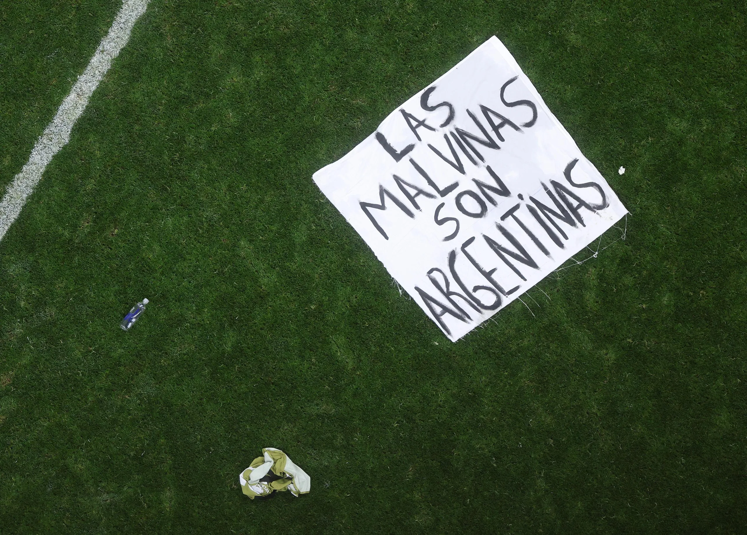 Argentina’s Malvinas banner is seen on the pitch following Argentina’s 2-1 win