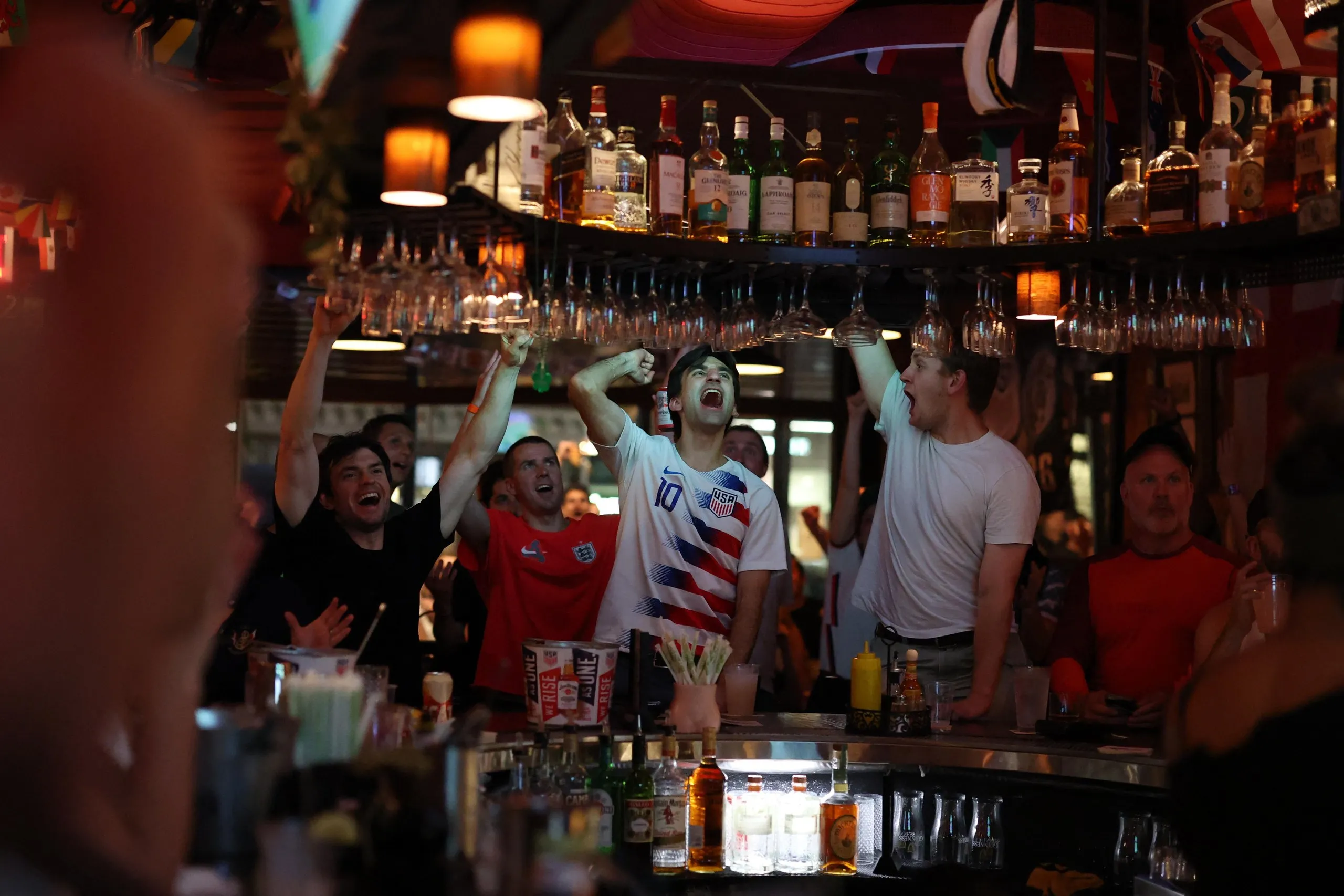 people cheering in a bar 