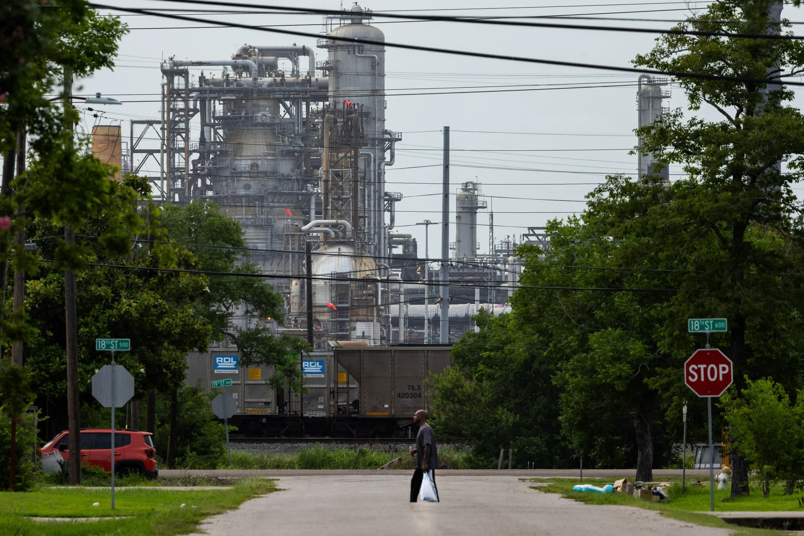 Jamal Johnson walks through his neighbourhood, which backs on to the Motiva refinery.