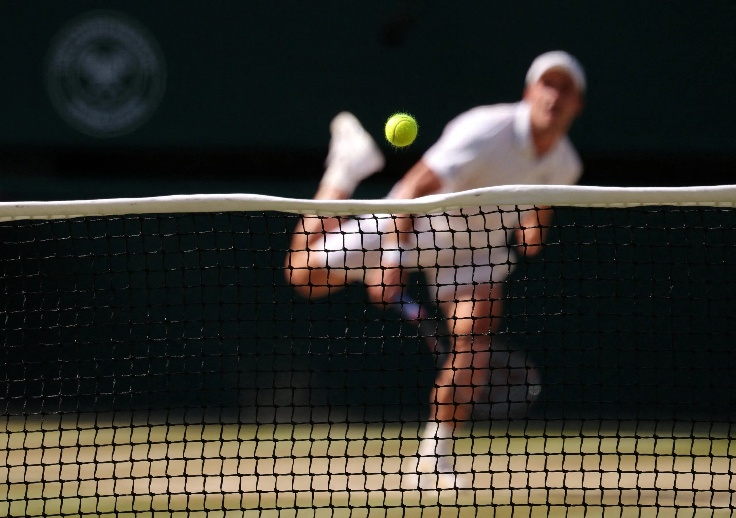 Arthur Fery in action as his serve clips the net against Flavio Cobolli