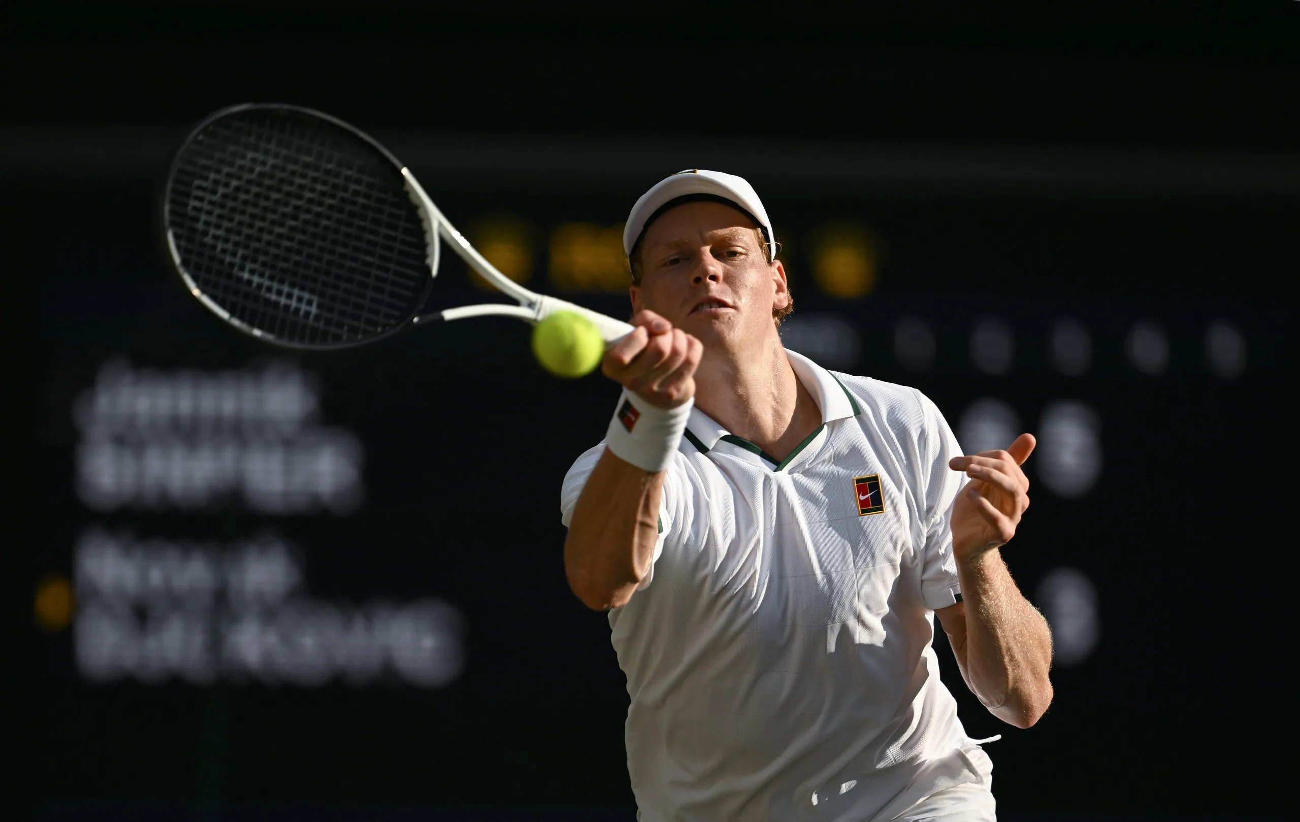 Jannik Sinner stretches to hit a return