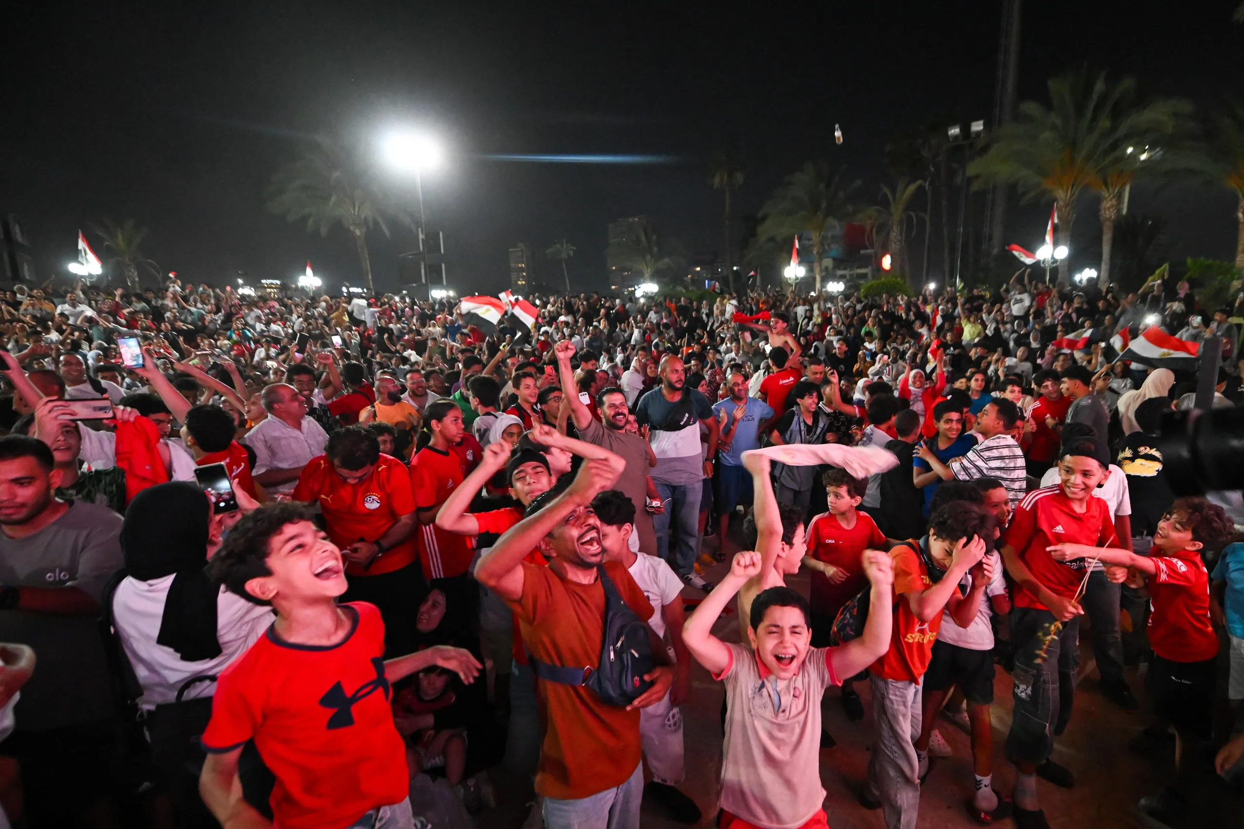 Fans in Cairo celebrate after the win over Australia in the last 32