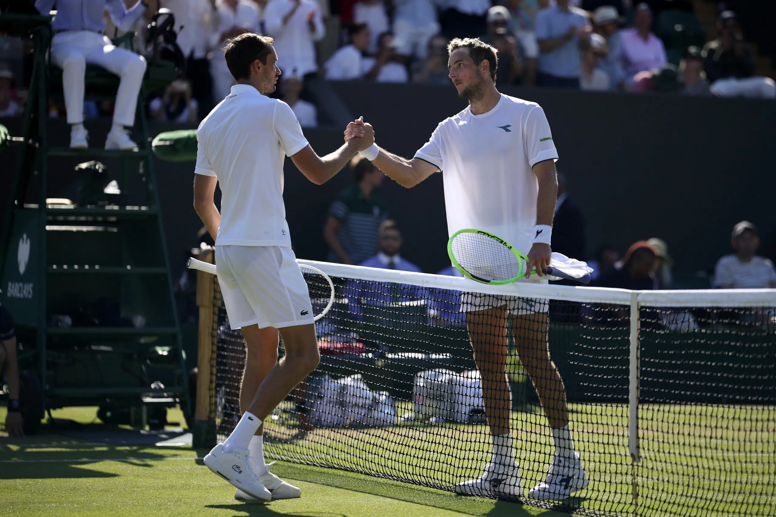 Jan-Lennard Struff (left) shakes hands with Daniil Medvedev after beating the Russian